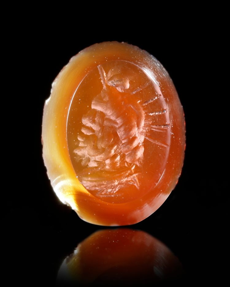 A ROMAN CARNELIAN INTAGLIO WITH A BUST OF SERAPIS, 1ST-2ND CENTURY AD