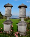 A PAIR OF SUBSTANTIAL CARVED LIMESTONE PEDESTAL URNS, SECOND HALF 20TH CENTURY