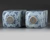 A pair of Chinese blue and white square bottles and silver covers