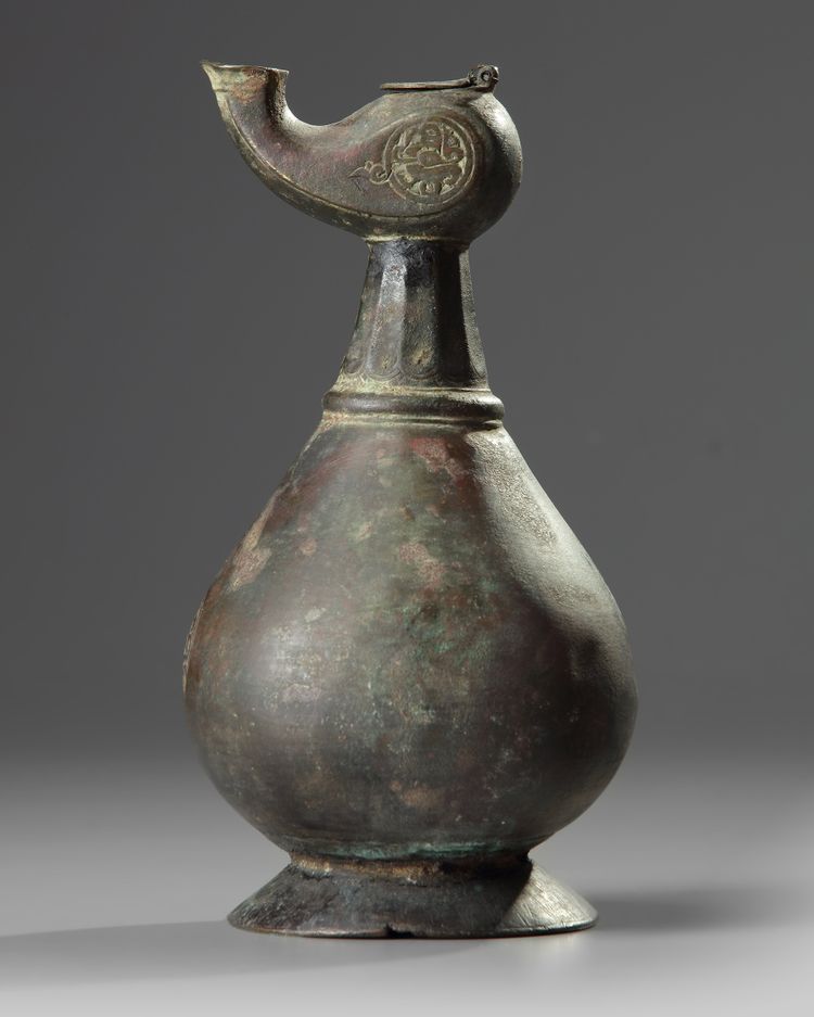 An Islamic bronze oil lamp