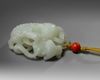 A Chinese white jade 'Buddhist lion and cubs' carving