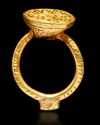 A GOLD INSCRIBED SEAL RING