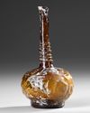 AN AMBER GLASS LOBED BOTTLE, PERSIA 9TH-11TH CENTURY