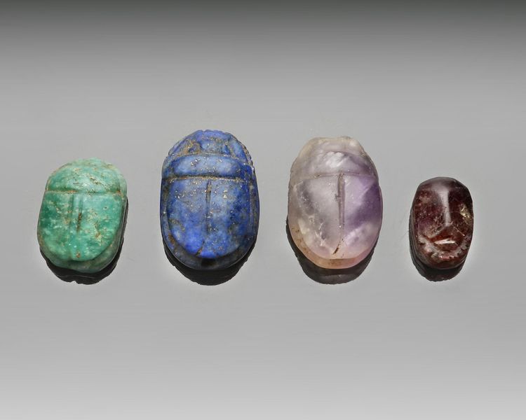A GROUP OF FOUR HARD STONE SCARABS, CIRCA 1500-500 B.C.