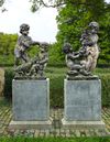 A PAIR OF SCULPTED LIMESTONE FIGURAL GROUPS OF PUTTI, LATE 19TH CENTURY