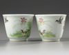 A pair of Chinese famille rose 'bird and lily' cups