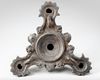 A ROMAN BRONZE THREE-NOZZLED OIL LAMP WITH THEATRE MASK AND ROSETTES AS DECORATION, CIRCA 1ST-2ND CENTURY A.D.