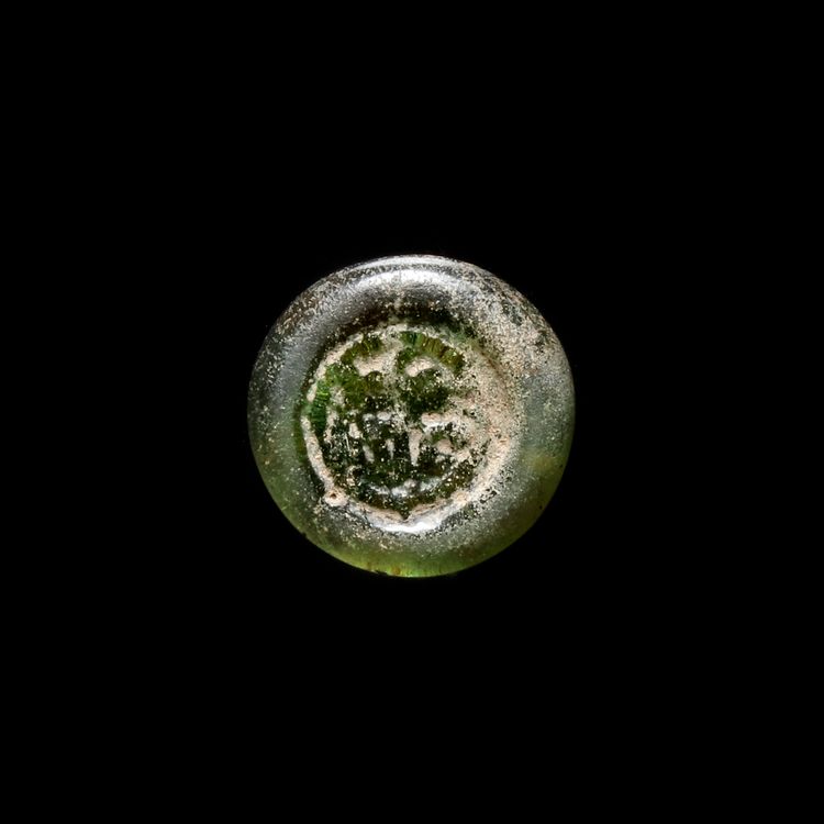A FATIMID GLASS WEIGHT OF DIRHAM, EGYPT AL-HAKIM BI-AMR ALLAH (386AH-411AH/ 996AD-1021AD)