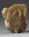 A Chinese celadon and russet jade 'boy and goose' carving