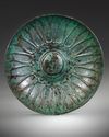 AN ACHAEMENID BRONZE DECORATED PHIALE, CIRCA 6TH-4TH CENTURY B.C.
