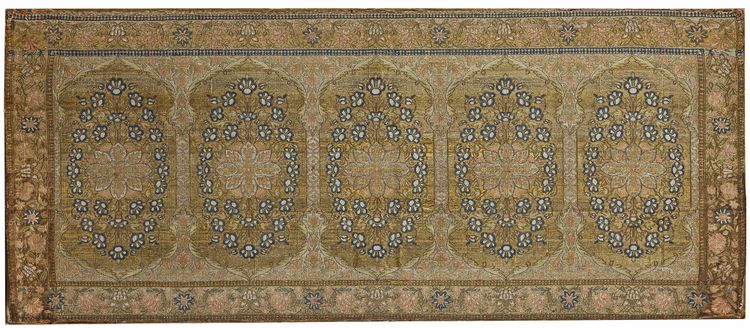 AN EMBROIDERY MOUNTED ON A PANEL