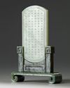 A CHINESE PALE CELADON JADE PLAQUE IN A SPINACH GREEN JADE STAND, 20TH CENTURY
