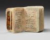 AN ILLUMINATED MINIATURE OTTOMAN QURAN