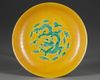 A CHINESE YELLOW-GROUND GREEN-ENAMELLED 'DRAGON' SAUCER,QING DYNASTY (1644–1911)