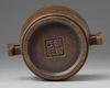 A CHINESE BRONZE TWIN-HANDLED CENSER