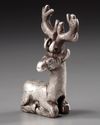 AN ELAMITE SILVER RECLINING STAG, CIRCA 2ND CENTURY B.C.