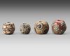 A GROUP OF FOUR GLASS BEADS ROMAN, 1ST CENTURY AD