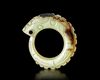A LIGHT GREEN JADE OUROBOROS DRAGON PENDANT, CHINA, WESTERN ZHOU DYNASTY