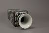 A famille noir square-section vase