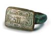 AN ISLAMIC KUFIC INSCRIBED BRONZE RING