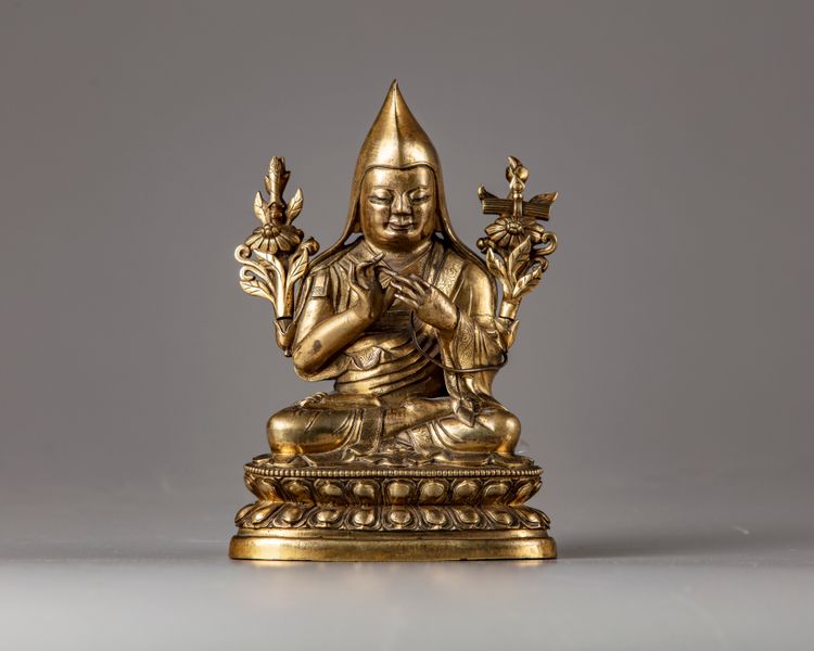 A Sino-Tibetan gilt bronze figure of a Lama