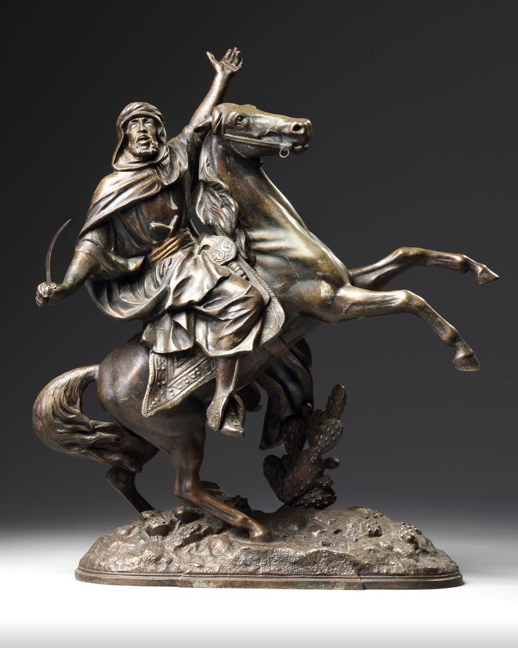 AN ORIENTAL BRASS STATUE 