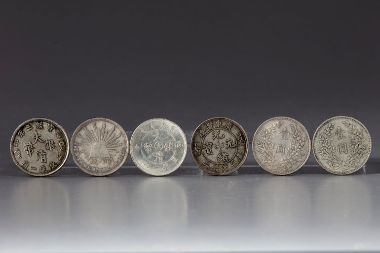 Five Chinese silver coins and a silver Mexican peso