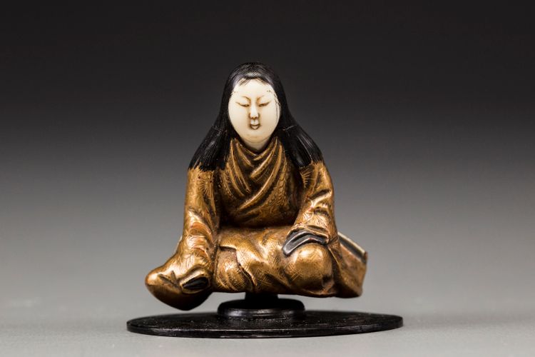 An ivory and laquer Netsuke