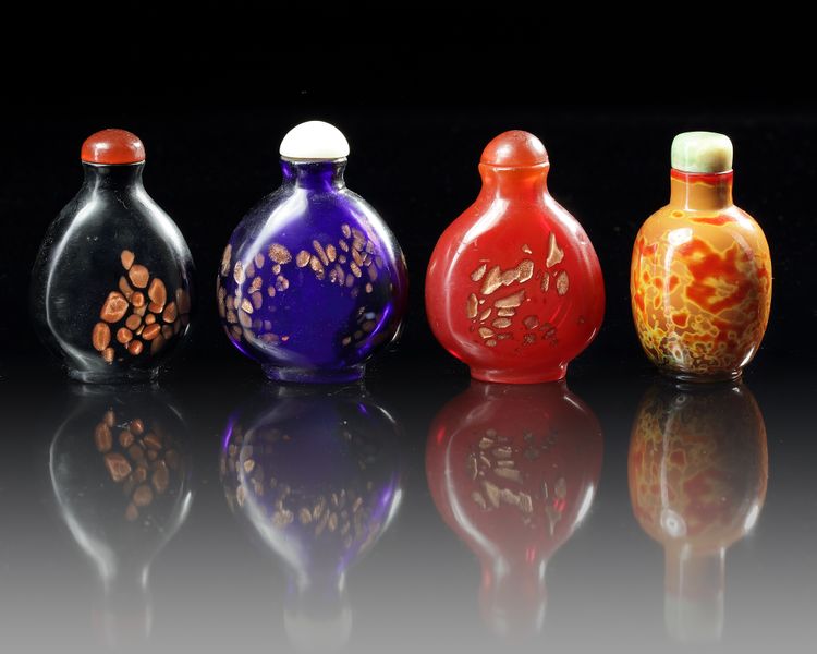 A GROUP OF FOUR CHINESE PEKING GLASS SNUFF BOTTLES