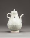 A Chinese celadon-glazed carved ewer and cover