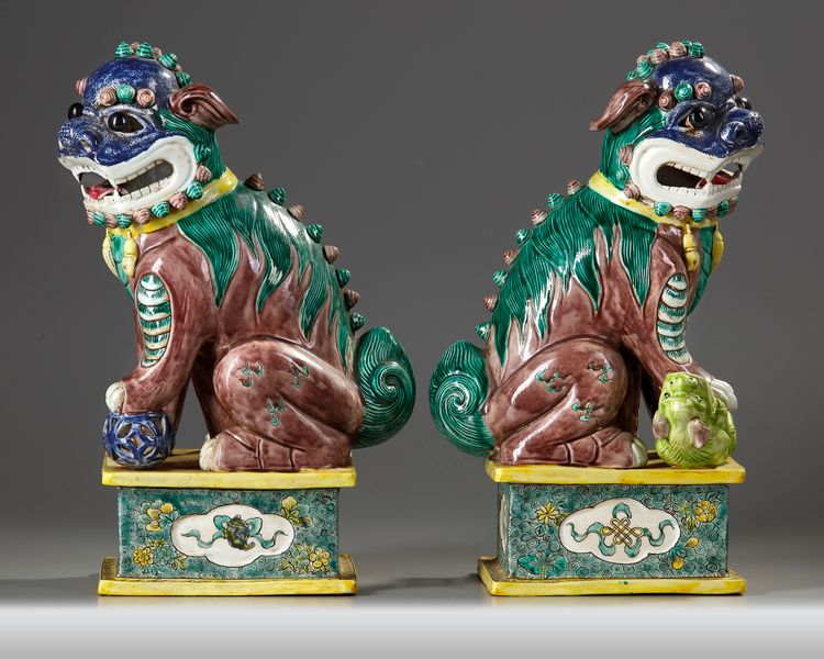 A LARGE PAIR OF CHINESE GLAZED-BISCUIT FAMILLE-VERTE FIGURES OF BUDDHIST LIONS, QING DYNASTY, 19TH CENTURY