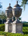 A PAIR OF LARGE AND IMPRESSIVE LIMESTONE CARVED GARDEN URNS ON PEDESTALS, LATE 20TH CENTURY