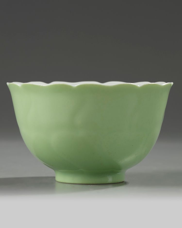 A Chinese pale-green glazed moulded 'floral' bowl