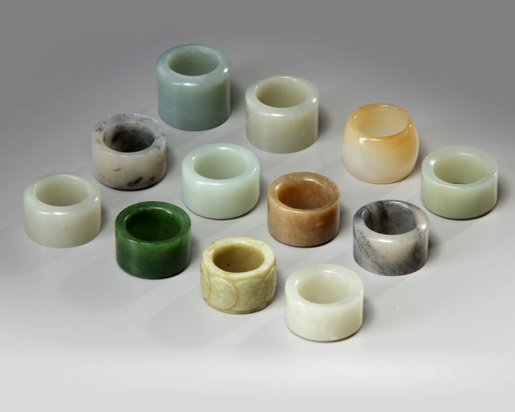 A group of twelve Chinese jade and agate archer rings