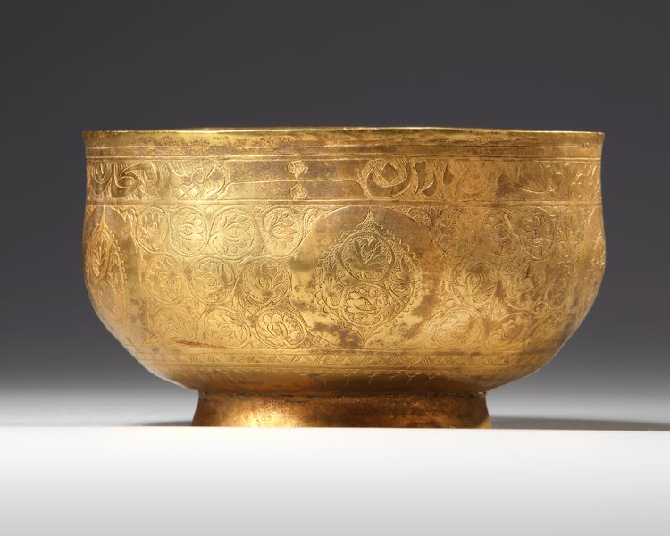 A PERSIAN GILT COPPER BOWL