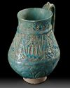 A TURQUOISE GLAZED POTTERY EWER, PROBABLY NISHAPUR, 12TH CENTURY