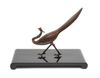 A stylised bronze phoenix-bird on a black lacquered plinth in a box