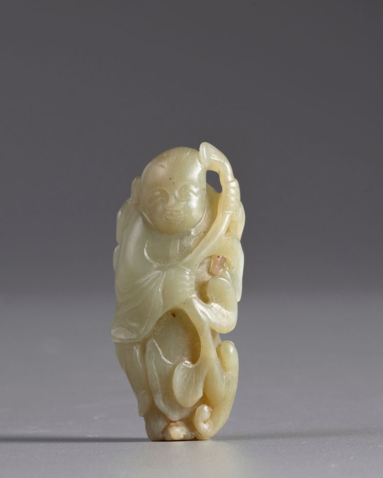 A Chinese pale celadon jade 'boy and lingzhi' carving