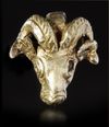 A NEO-ELAMITE GOLD FOIL-COVERED SILVER RAM HEADED AMULET PENDANT, CIRCA 1100-540 B.C.