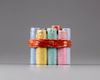 A famille rose 'candles tied by a ribbon' pot and cover