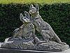 A SCULPTED LIMESTONE GROUP OF TWO DOGS, EARLY 20TH CENTURY, INSCRIBED TH. CARTIER (FRENCH 1879-1943)