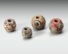 A GROUP OF FOUR GLASS BEADS ROMAN, 1ST CENTURY AD