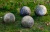 A GROUP OF FOUR LIMESTONE ORNAMENTAL SPHERES, LATE 20TH CENTURY