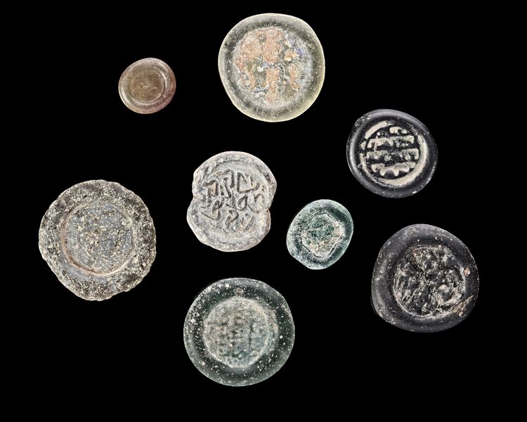 A GROUP OF EIGHT EARLY ISLAMIC GLASS WEIGHTS, 10TH-11TH CENTURY