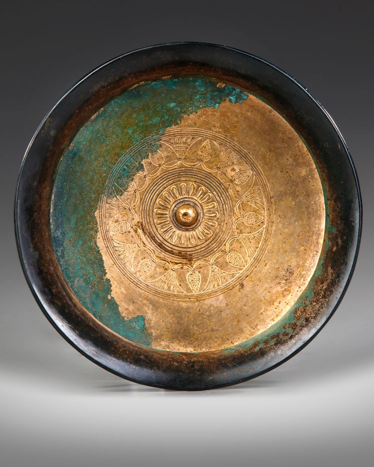 AN ACHAEMENID BRONZE LOTUS PHIALE, CIRCA 6TH-5TH CENTURY B.C.