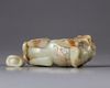 A CHINESE CELADON AND RUSSET JADE BUDDHIST LION WATER DROPPER, CHINA, QING DYNASTY (1644-1911)