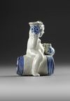 A BLUE AND WHITE BACCHUS ON A WINE BARREL, PROBABLY BRUSSELS 18TH CENTURY