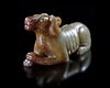 A CHINESE JADE OF A RECLINING DOG, HAN DYNASTY (206 BC–220 AD)