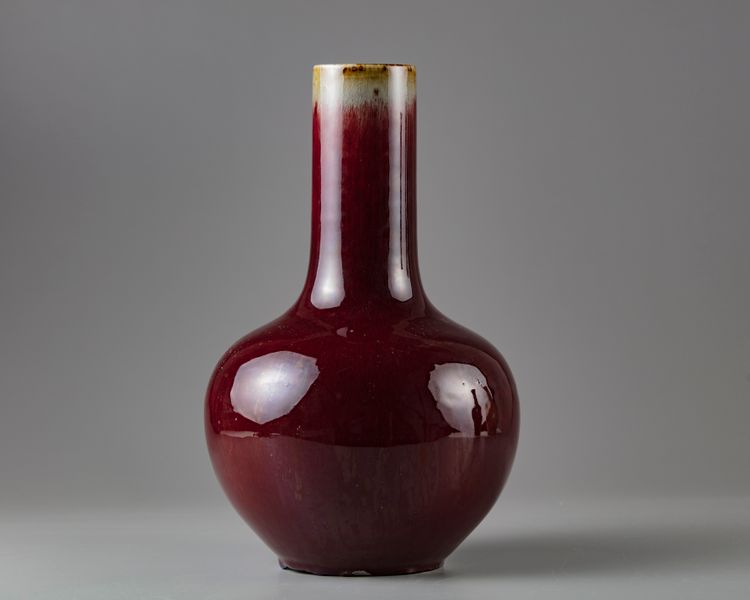 A red glazed bottle vase