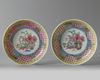 A pair of Chinese famille rose 'floral' cups and saucers